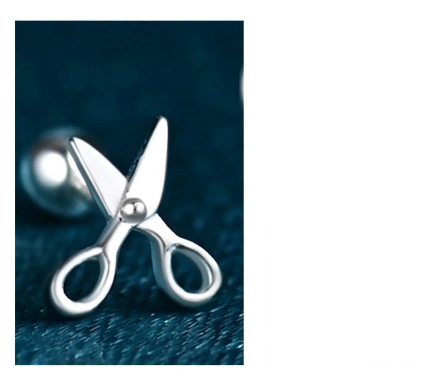 A pair of silver screw-back ear nails with a miniature scissors design on the screw component.