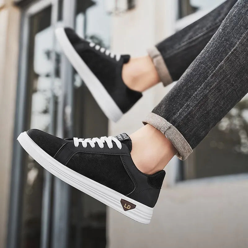 Men's black snake pattern leather low-top sneakers with round toe and flat rubber sole.