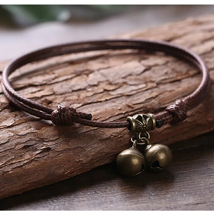 Nylon dog collar with brass bell shown in black rope colour, adjustable size 8 to 17 cm