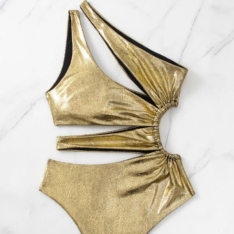Gold women's one-piece swimsuit with backless design and sleeveless construction