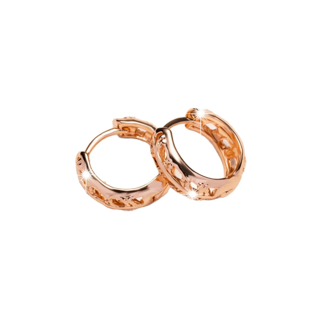 Rose gold hollowed leaf and heart shaped copper earrings on display