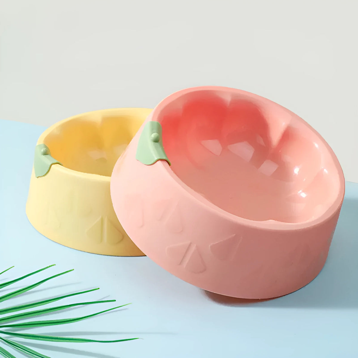 Green plastic double pet bowl with flower-shaped base for cat or small dog food and water.