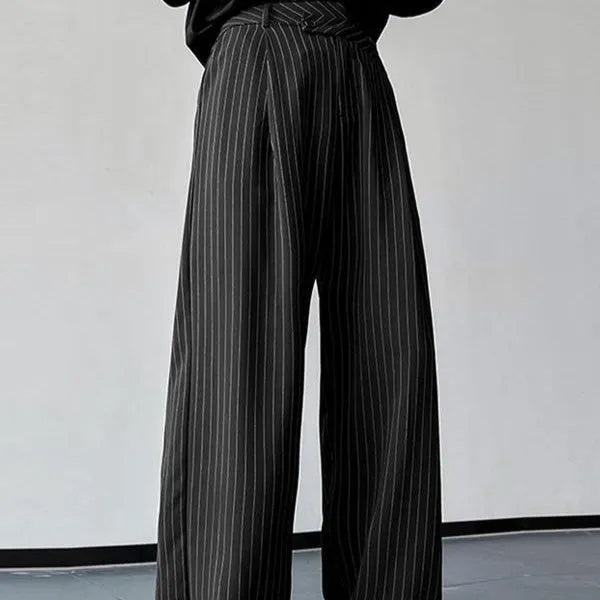 Men's black vertical striped pleated casual trousers showing elastic waistband and leg detail