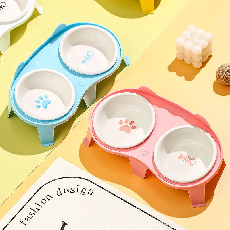 Blue ceramic cat food and water bowl set on a white elevated stand with storage hook