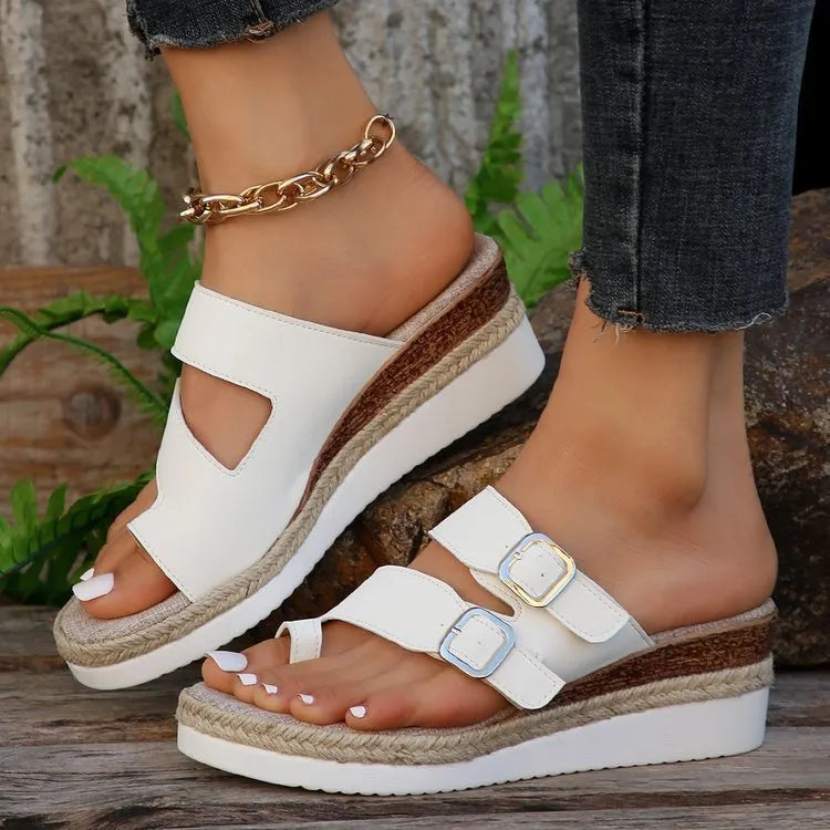 White woven patent leather women's wedge sandals with a peep toe and finger-fit strap design.