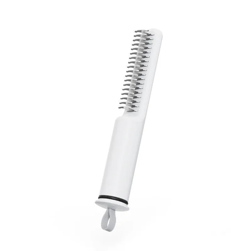 Stainless steel dematting comb for dogs with a user-friendly handle on a pink background.