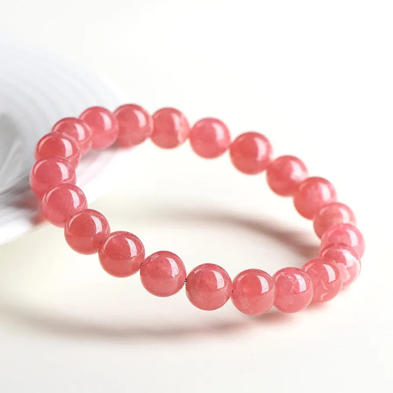 Women's geometric crystal bracelet with longevity lock in natural red rhodochrosite patterns showing angular bead shapes