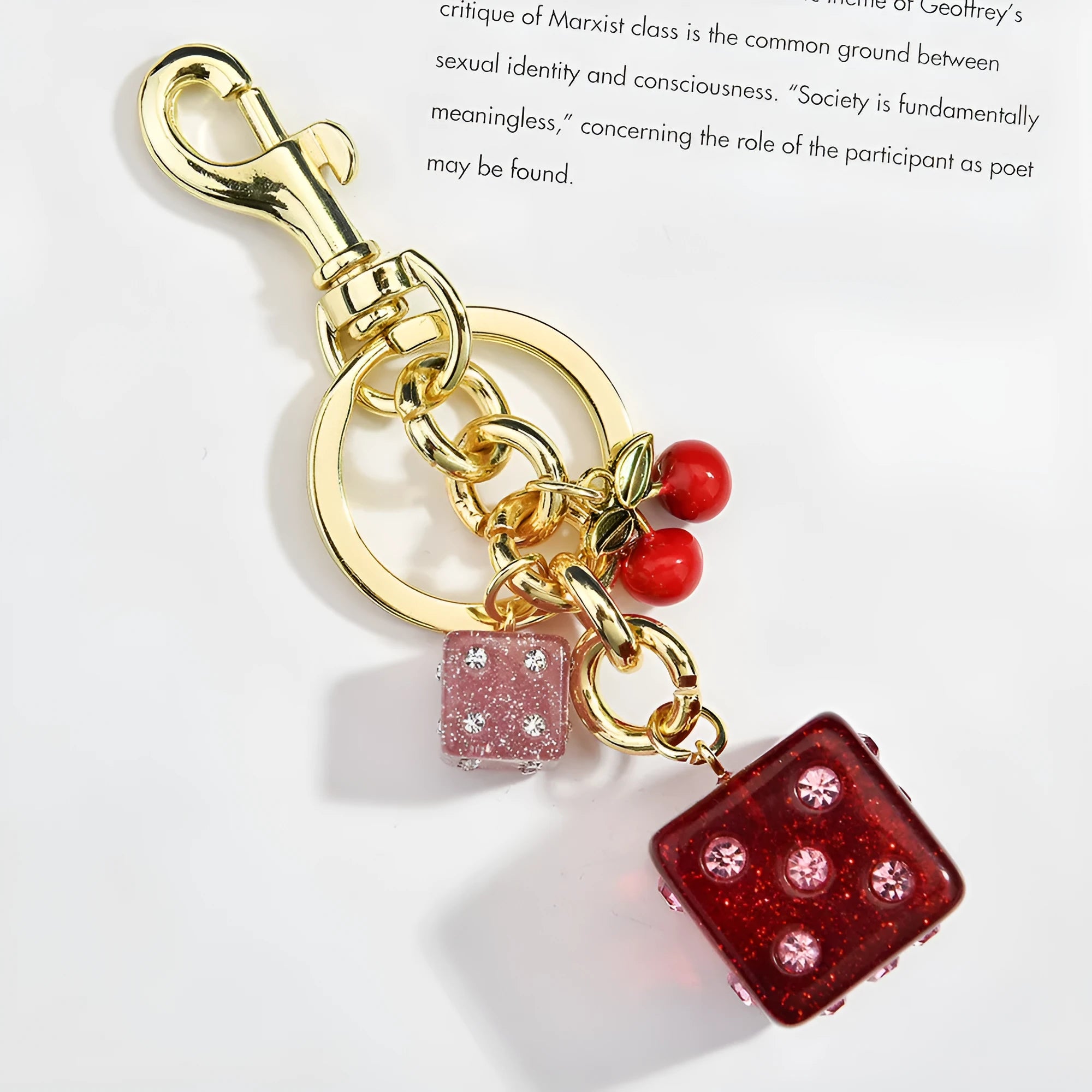 Square metal keychain pendant with a vintage cherry red and white dice design.