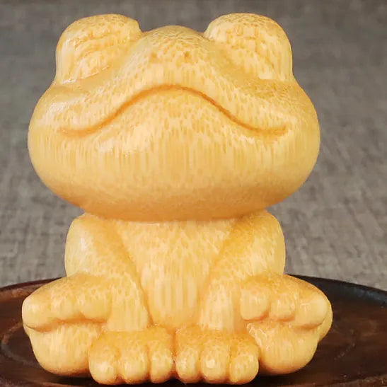 Solid bamboo smiling frog carving ornament next to a 120ml oil glove brush.