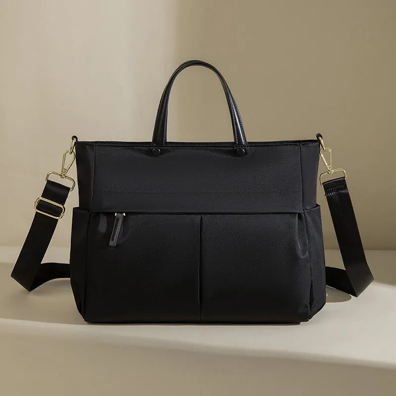 Women's oxford cloth laptop briefcase in elegant black showing open pocket and stitching detail