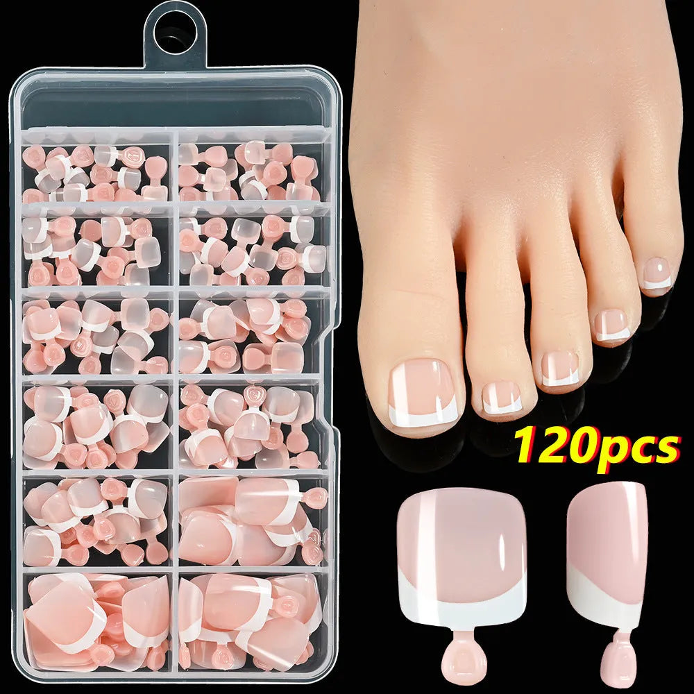 120 piece box of square short French style artificial toe nails with white tips on nude base.