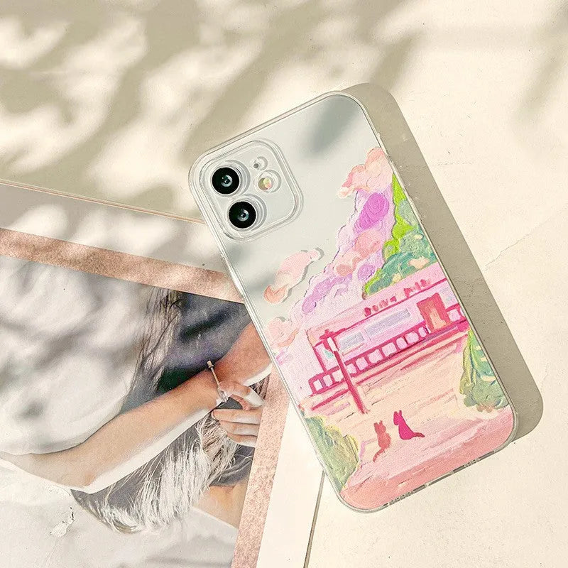 White silicone iPhone case with a colourful cartoon illustration of two cats on the back.
