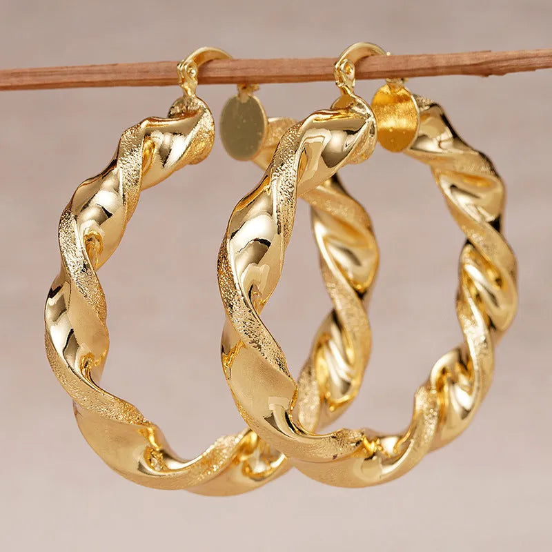 Geometric drop-shaped women's ear clip with ring design in electroplated copper.
