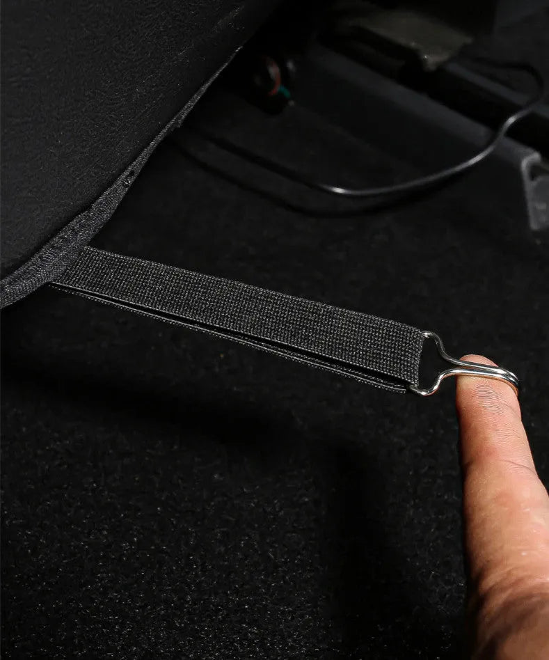 Two black leather motorcycle seat anti kick pads showing size and texture.