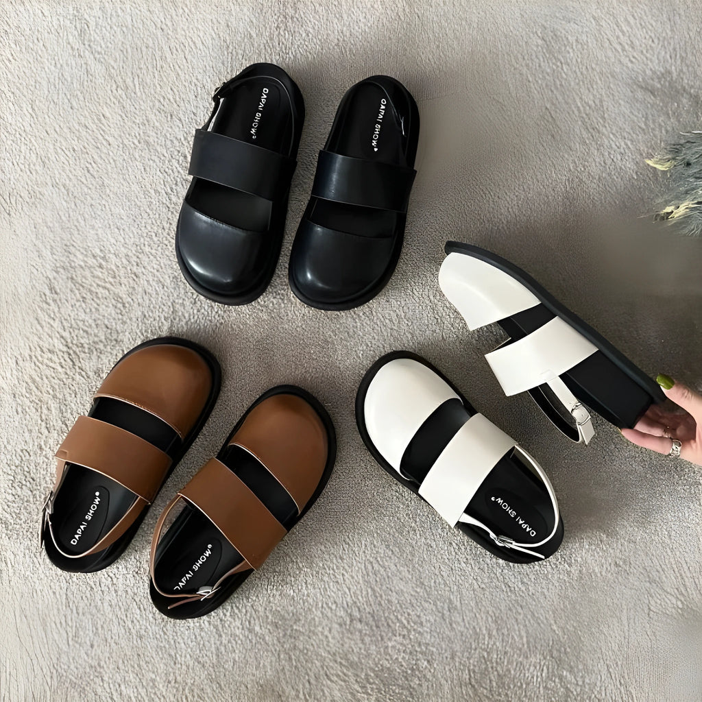 Retro apricot women's sandals with a raised sole, closed toe, and an adjustable ankle strap buckle.