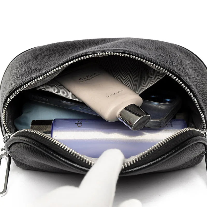 Women's saddle-shaped PU leather messenger bag in black with single shoulder strap and sewing line detailing