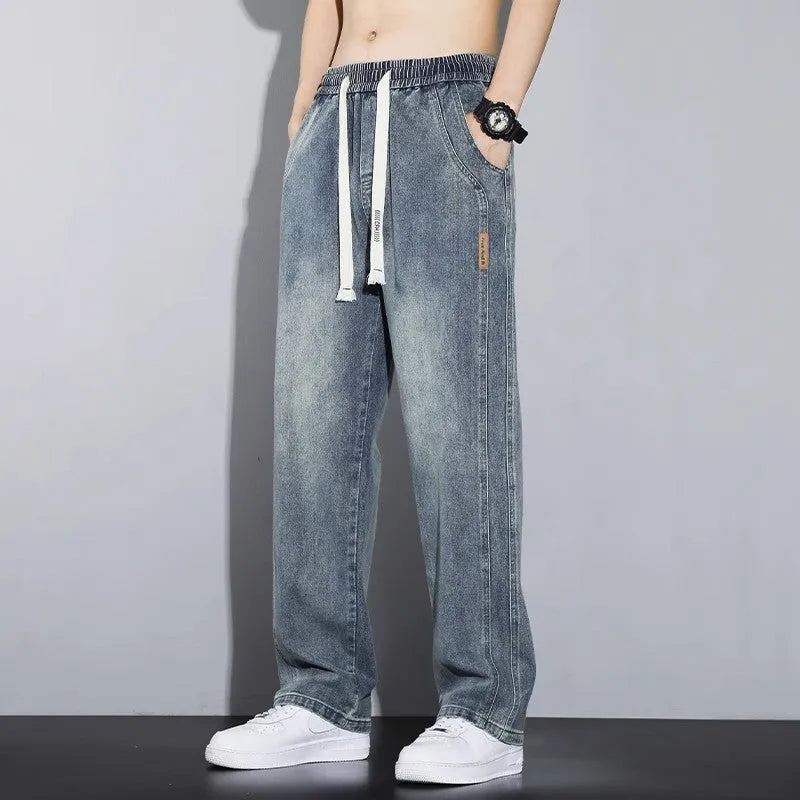 Men's loose fit straight leg cotton denim jeans with elastic waist and rope closure, available in four colours