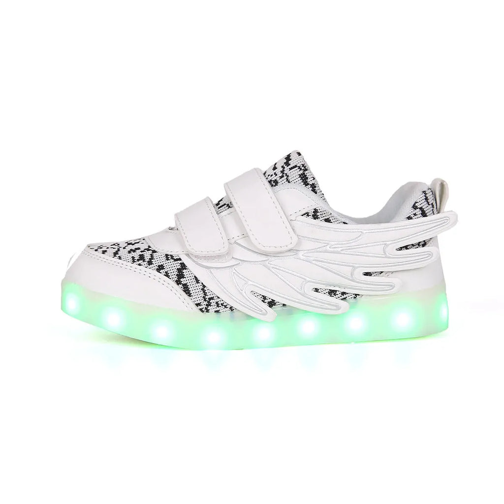 Children's plum red sneakers with colourful LED lights glowing in the soles.