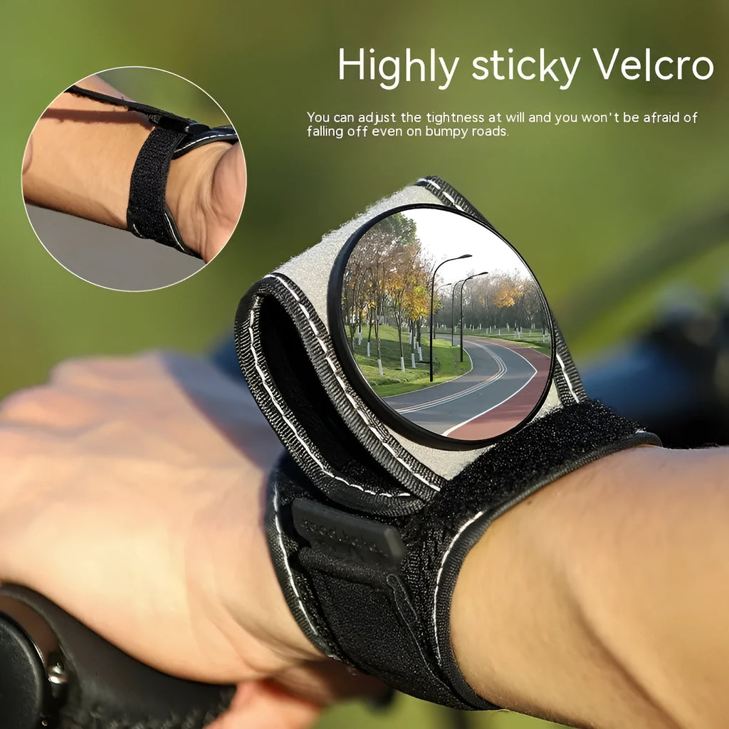 Black nylon wrist-mounted bicycle rear-view mirror with velcro strap and armoured glass reflective surface.
