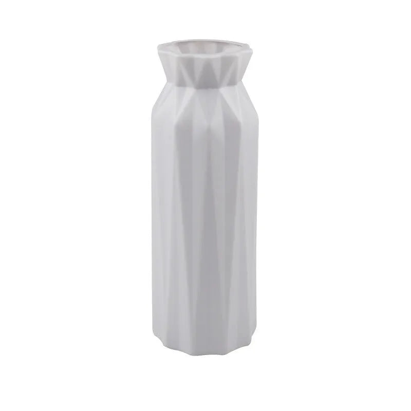 Simple green melamine plastic vase with a wide 7.2 cm base on a wooden table.