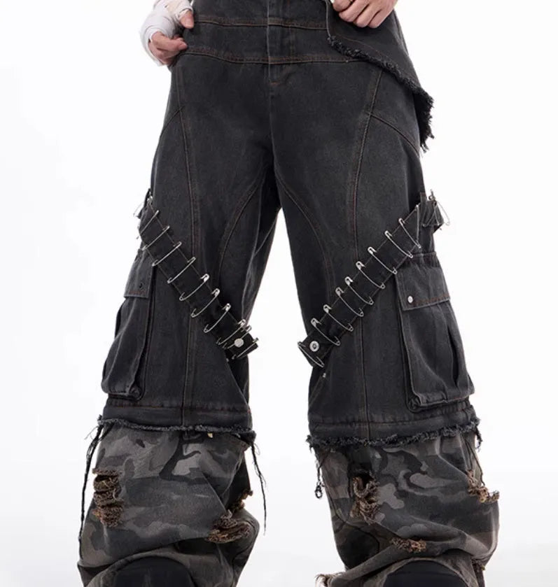 Men's grey cotton jeans with camouflage print, splicing panels, and decorative pin and ribbon details.