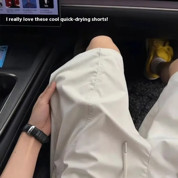 Men's quick-drying sports shorts in creamy-white, black, and navy blue colours