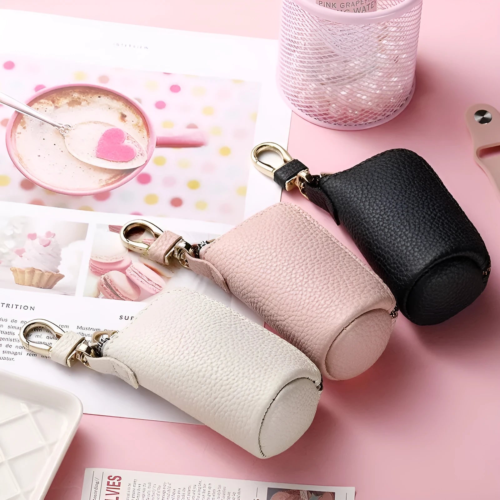 Simple black PU leather zipper key ring for car keys on a grey background.