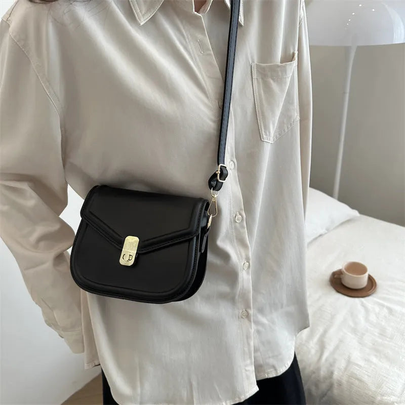 Soft textured PU leather messenger bag with clamshell opening in dark brown colour