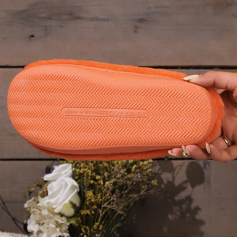 Orange Halloween pumpkin-themed plush slippers with a coral velvet upper and non-slip sole.