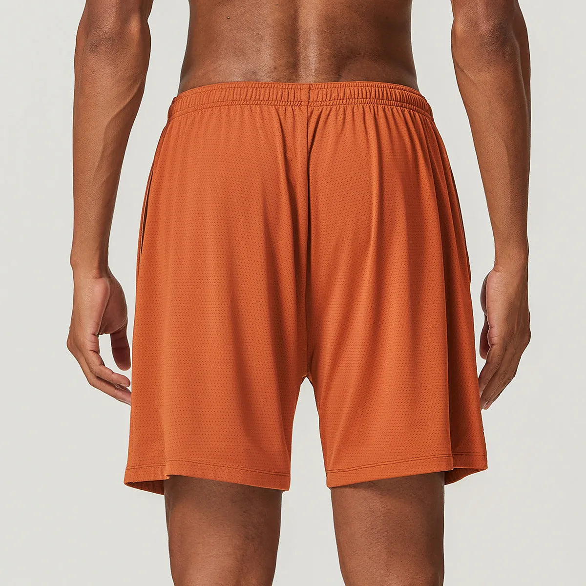 Men's quick-drying double-layer running shorts in khaki colour, showing mid waist and short length design.