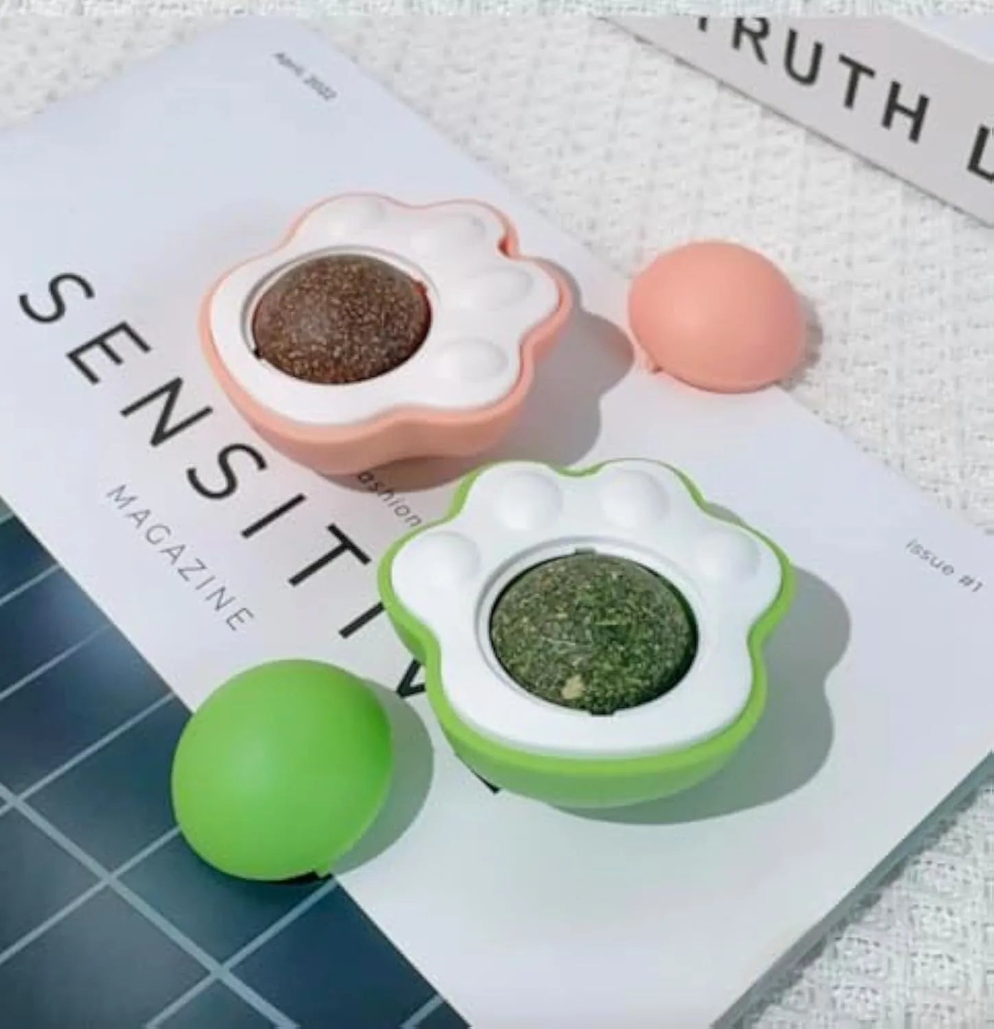 Catnip dental chew balls with edible vine components in blue, green and pink colours