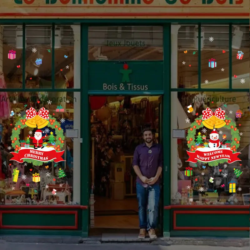 Two large colourful cartoon Christmas static cling wall stickers on a glass window