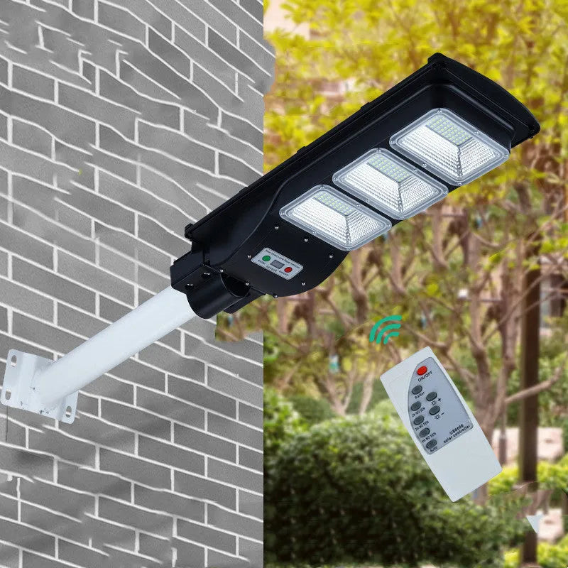 Integrated solar street light with aluminium housing and solar panel, showing remote control and outdoor installation