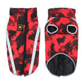 A large dog wearing a thick blue geometric print reflective jacket for cold weather.