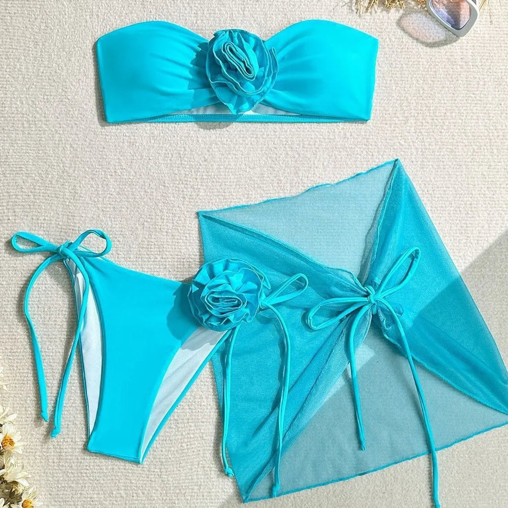 Women's pink tube top swimsuit with a large 3D flower tie and matching swim skirt.