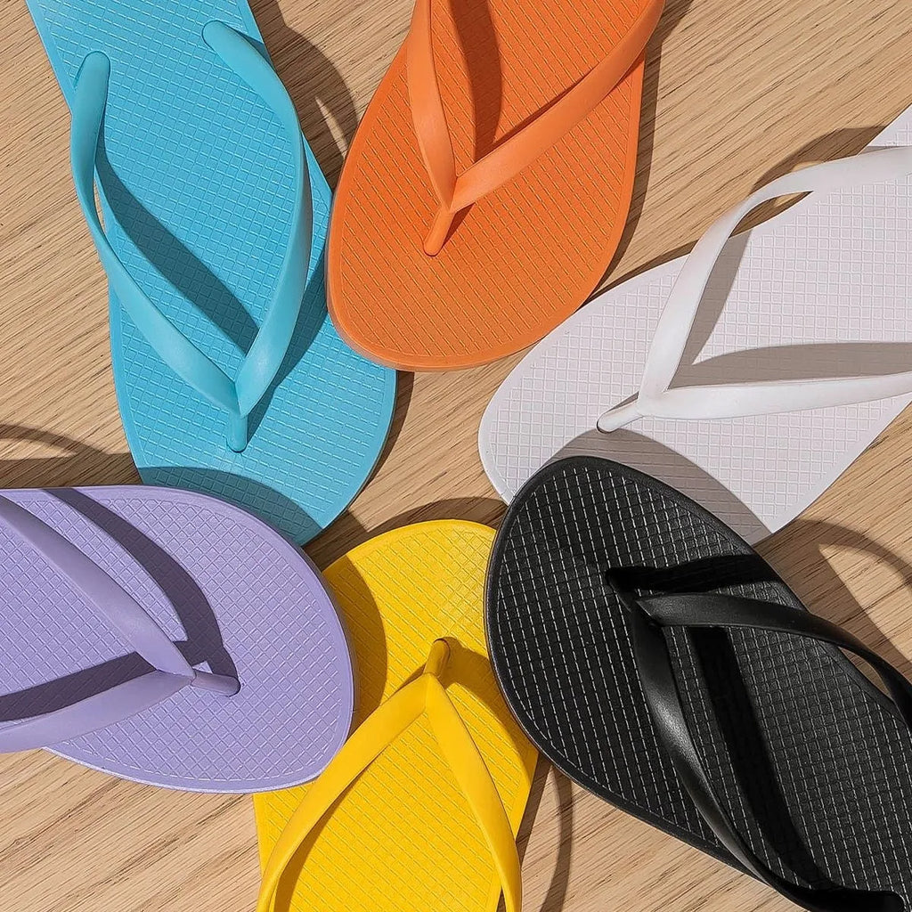 Orange foldable beach slipper with hollow out non-slip PVC sole, shown next to its folded size.