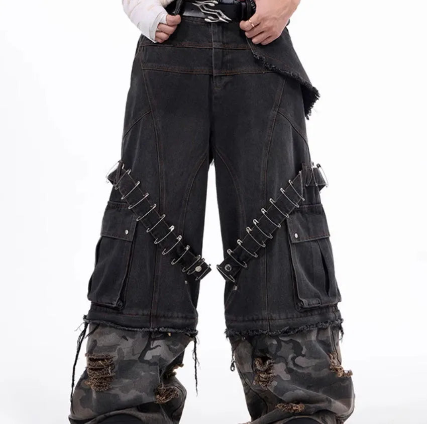 Men's grey cotton jeans with camouflage print, splicing panels, and decorative pin and ribbon details.