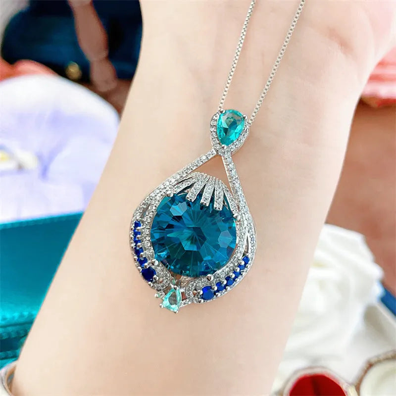 Blue fireworks cut gem geometric pendant necklace with water wave chain on woman