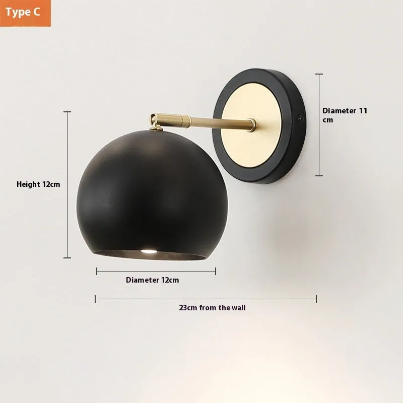 Nordic style iron wall lamp mounted beside a bed, showcasing its metal construction and adjustable light settings.