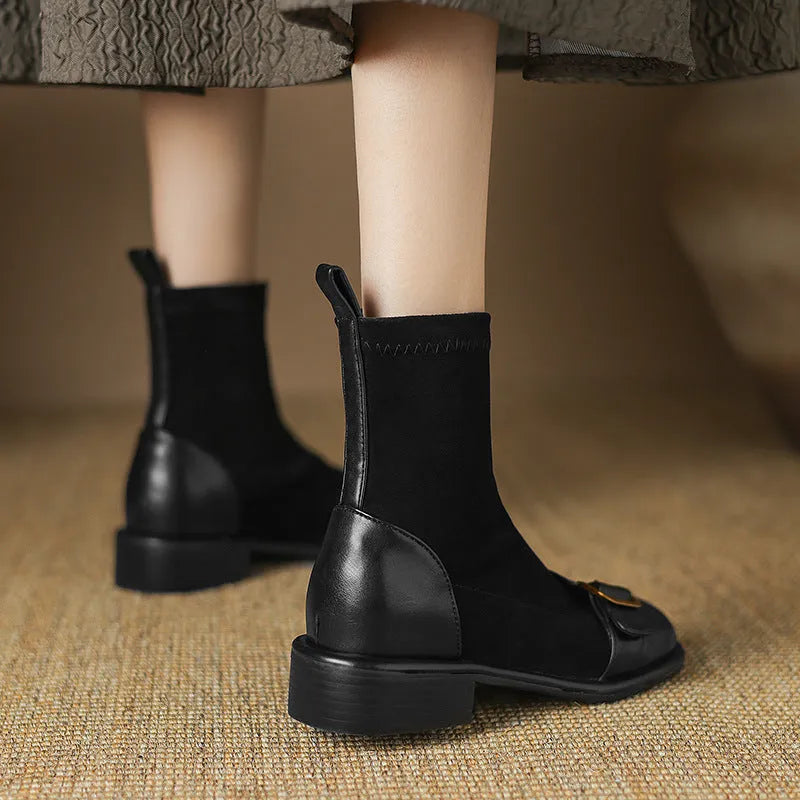 Women's black low heel Martin ankle boots with lace-up front and buckle stitch detail on a white background.