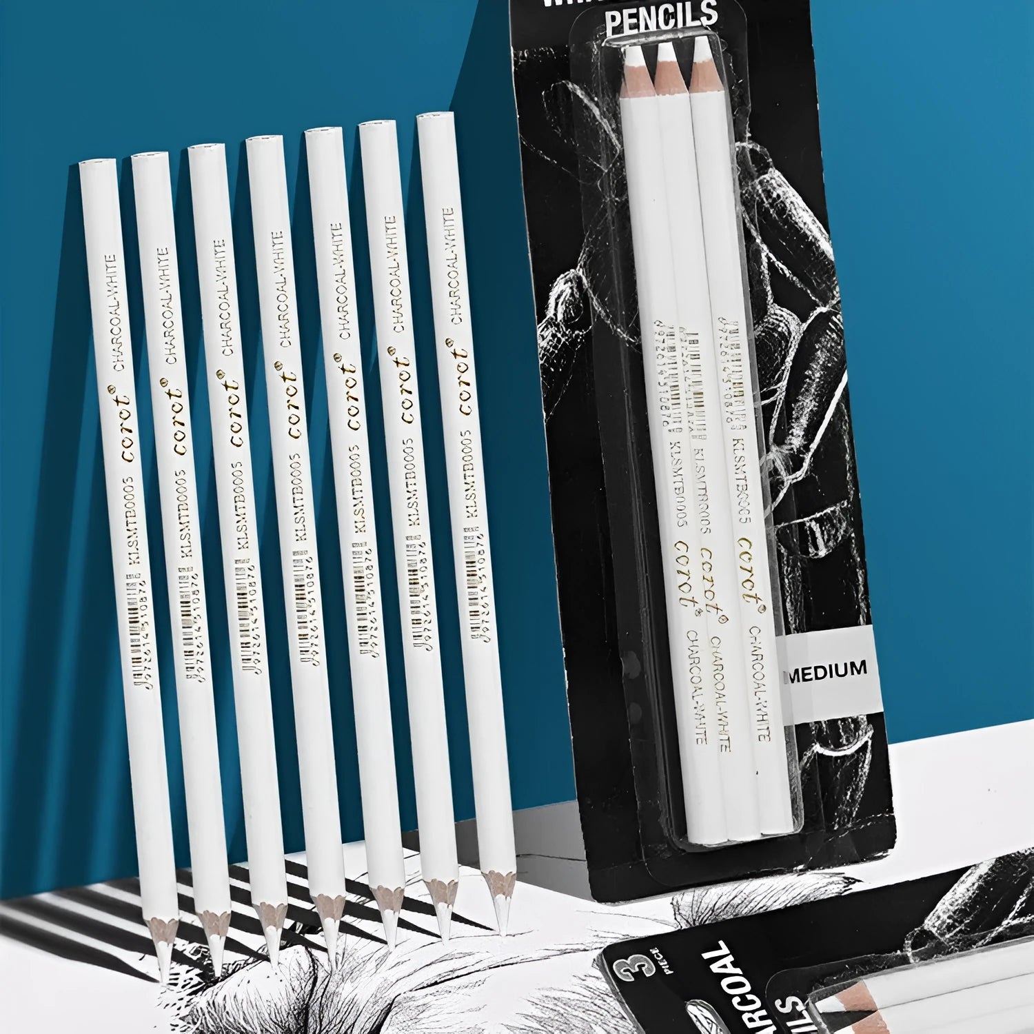 Set of three white charcoal sketching pencils with wooden barrels for highlighting on dark paper