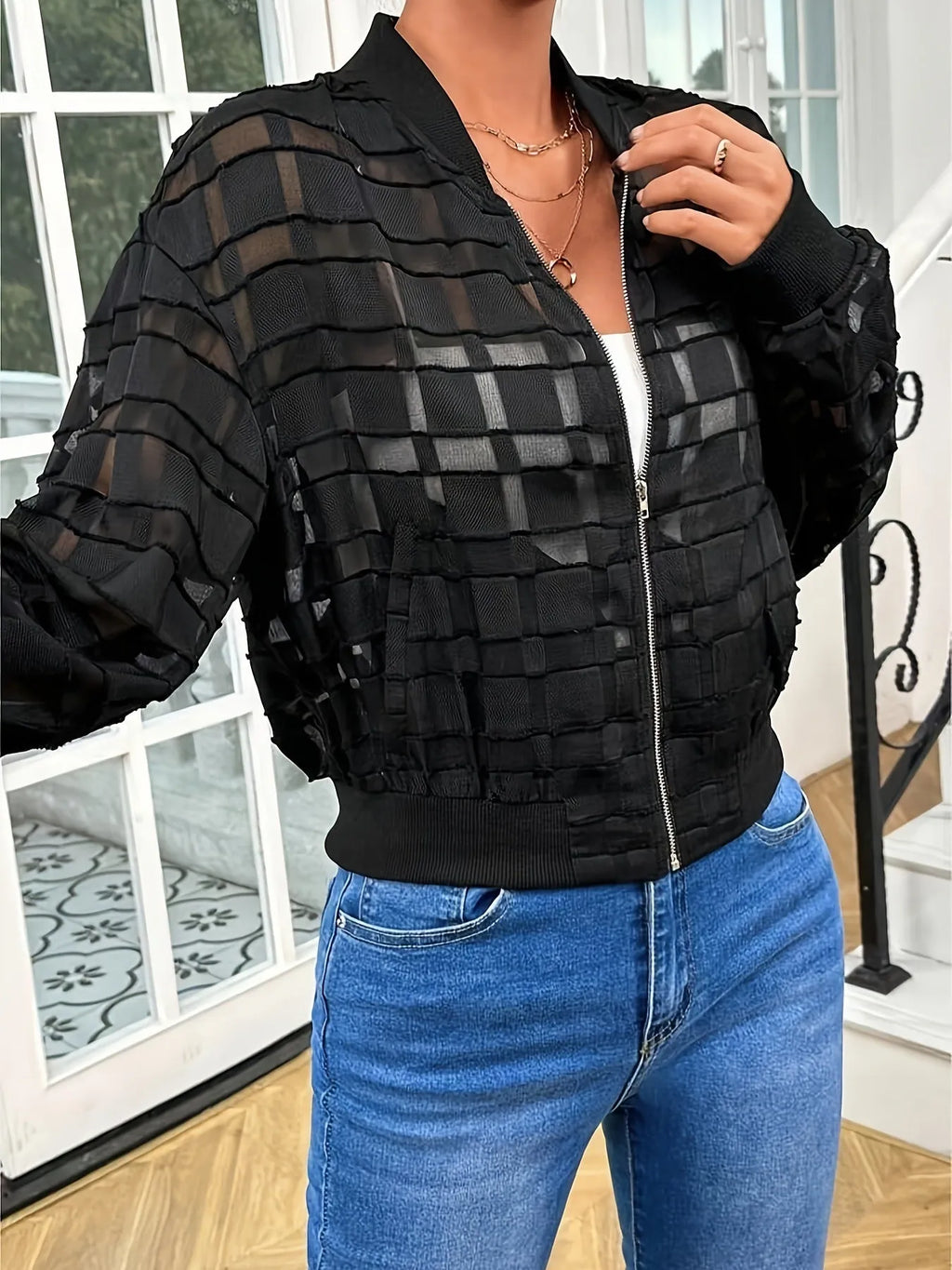 Black women's casual jacket with geometric pattern, semi-transparent fabric, and a full-length front zipper.