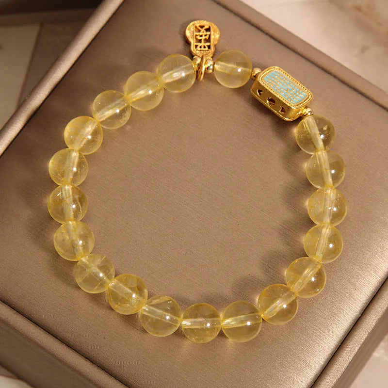 Women's yellow citrine crystal bracelet with rhinestone detailing on wrist