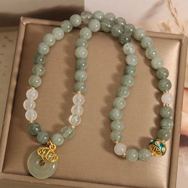 Women's green double-layer crystal bracelet with a peace buckle clasp and rhinestone details.