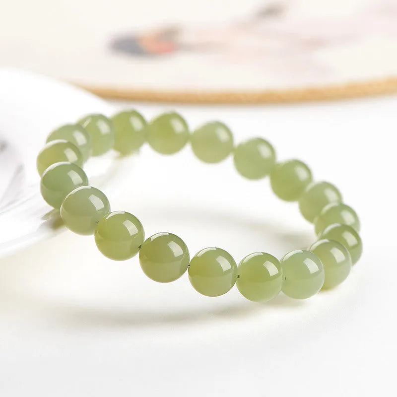 Polished Hetian jade ball bracelet showing ice-like clear beads in deep and light water variations