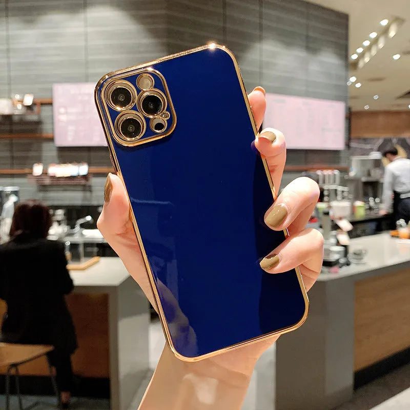 Gold plated and silicone stripe decorative case for iPhone on a solid colour background.