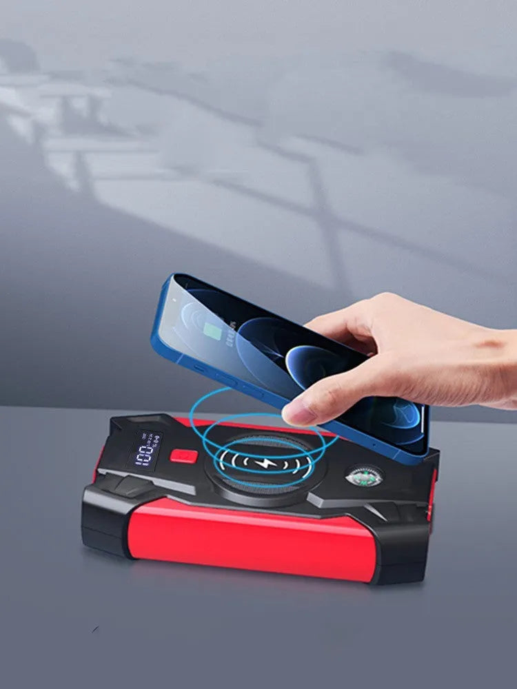 Red 12V car emergency jump starter power pack with battery clips and digital display