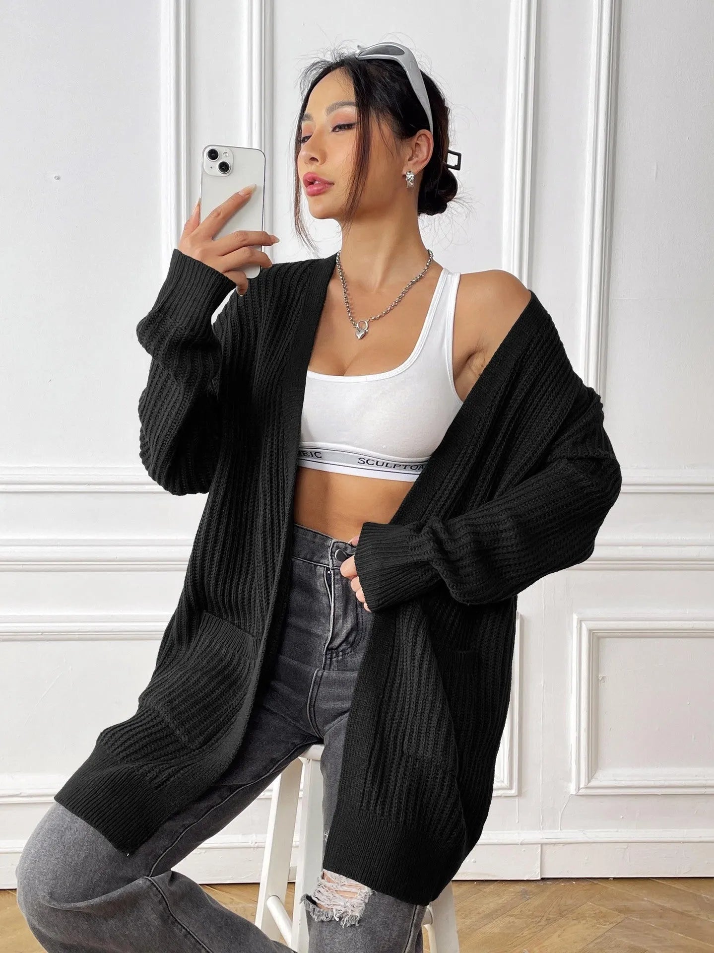 Womens double pocket acrylic cardigan in dark green colour showing mid-length design and loose fit