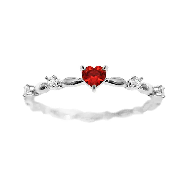 Gold or silver electroplated peach heart ring with zircon stones on a model's hand