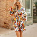 Orange floral print mini dress with lace trim, V-neckline, and long sleeves